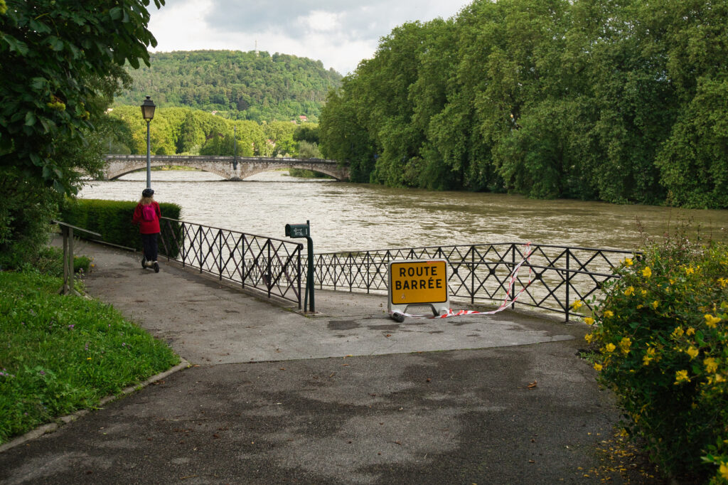 A woman passing by a flooded area in Europe's Crue Besançon. 