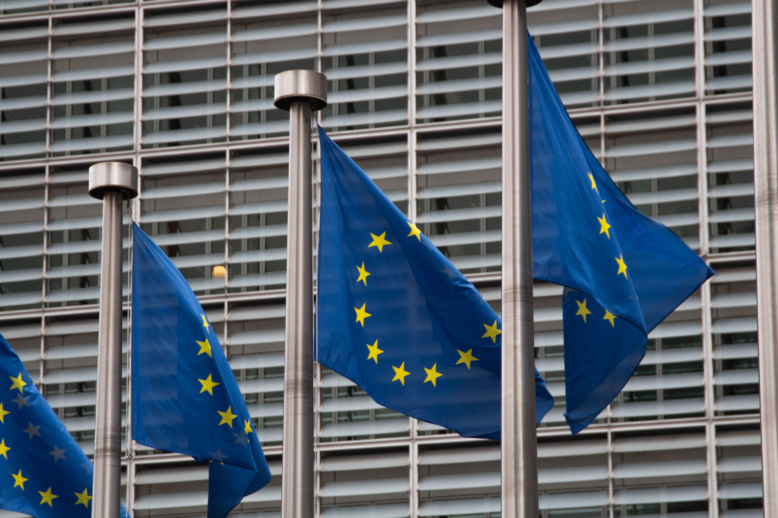 Photo of European Union flags in Brussels, next to the European Commission building.