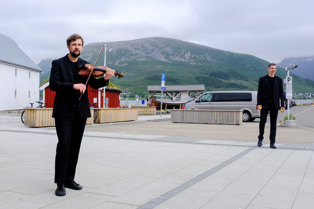 Two men - a violin player and a joggler - winding down between sessions at the GAIA Arctic Summit. 