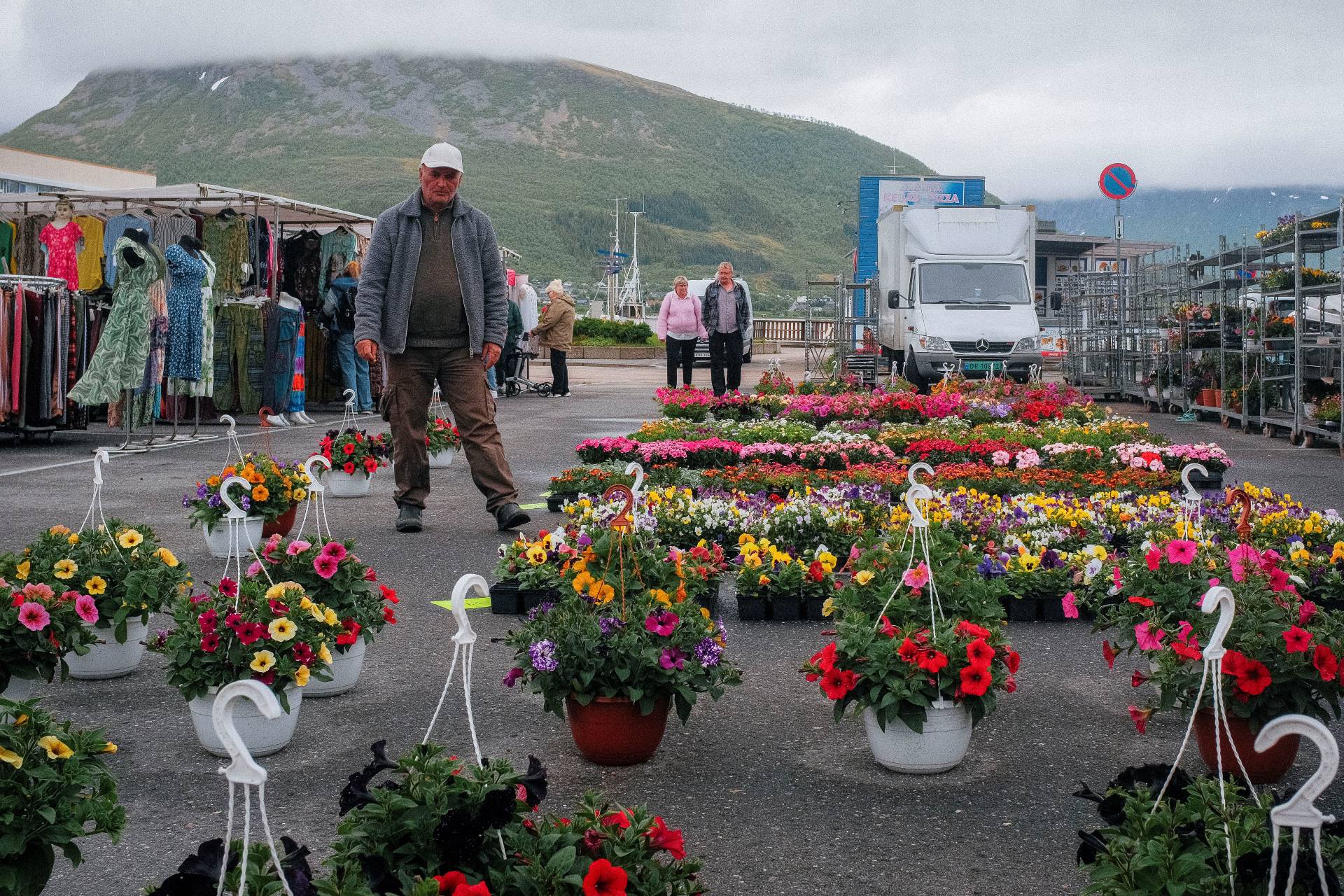 A trader stands over his stall at the flower market in Sortland, Norway.