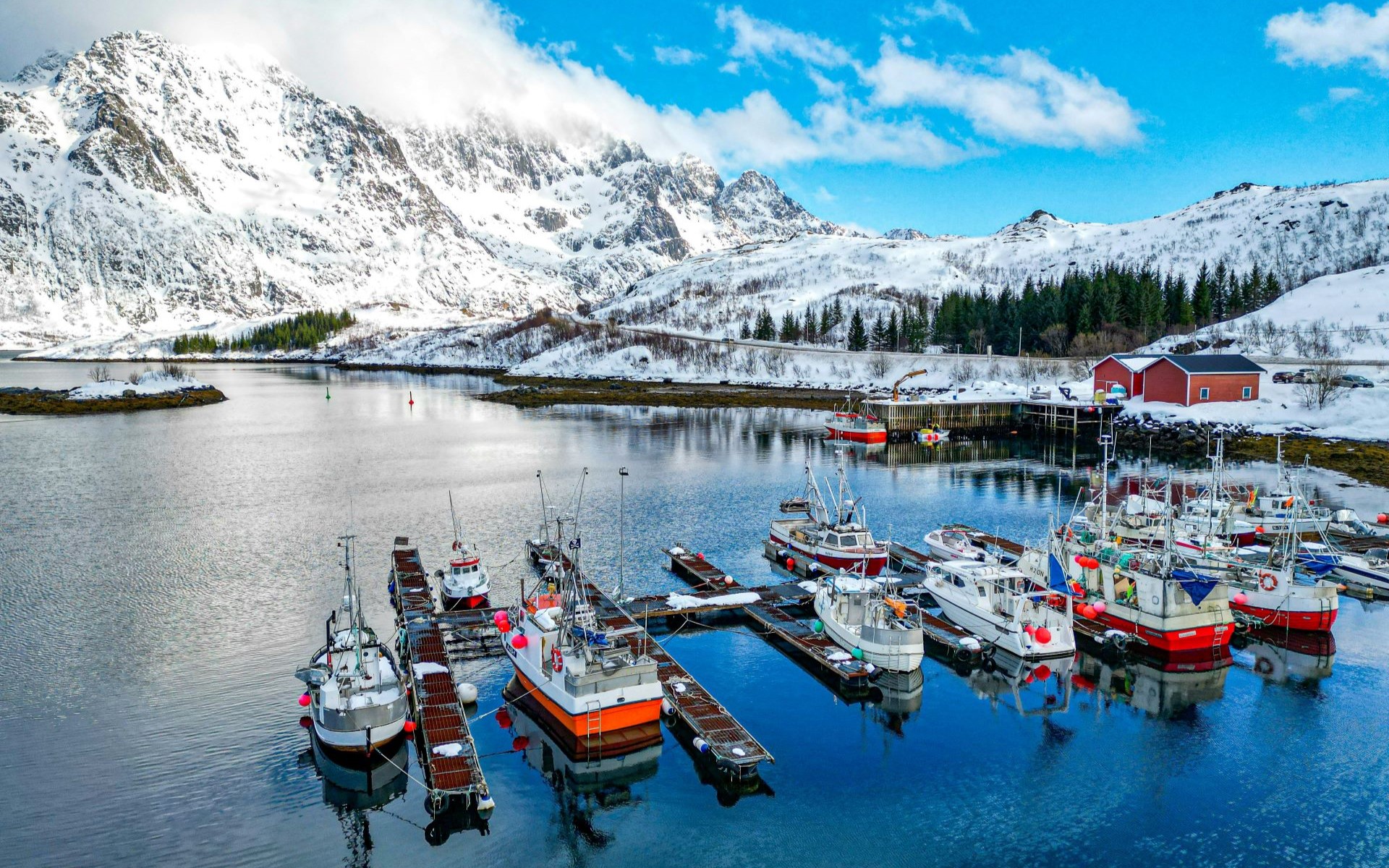 Photo of boats floating by the sharing stock in Lofoten in Norway.